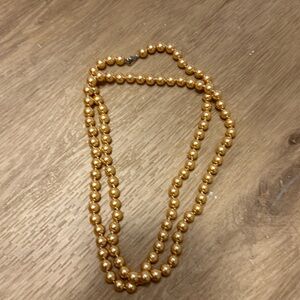 Long yellow/gold pearl necklace